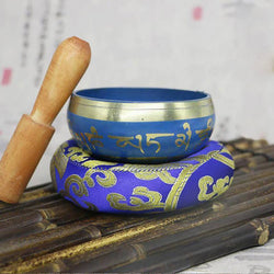 Blue singing bowl and wooden mallet